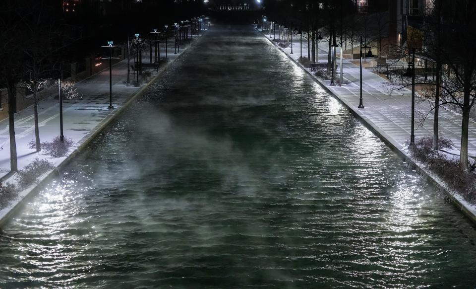 Steam rises from the Indianapolis Canal Walk on Thursday, Dec. 23, 2022 in Indianapolis. A winter storm with negative temperatures threatens holiday travel. 