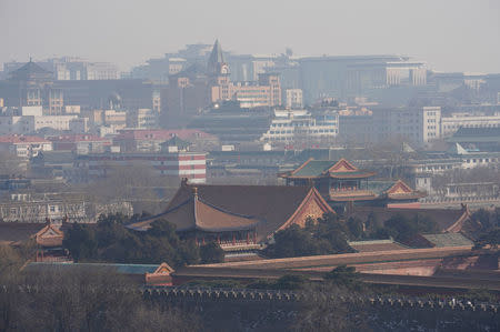 Forbidden City and other buildings are seen amid smog ahead of Chinese Lunar New Year in Beijing, China February 13, 2018. Picture taken February 13, 2018. REUTERS/Jason Lee