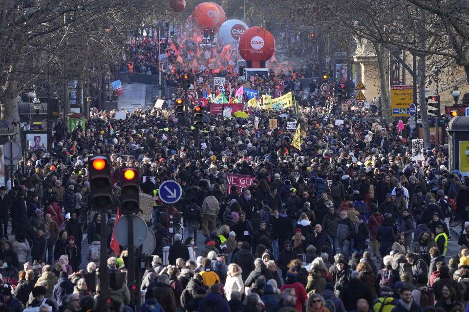 Protesters march during a demonstration against plans to push back France's retirement age, Tuesday, Feb. 7, 2023 in Paris. The demonstration comes a day after French lawmakers began debating a pension bill that would raise the minimum retirement from 62 to 64. The bill is the flagship legislation of President Emmanuel Macron's second term. (AP Photo/Michel Euler)