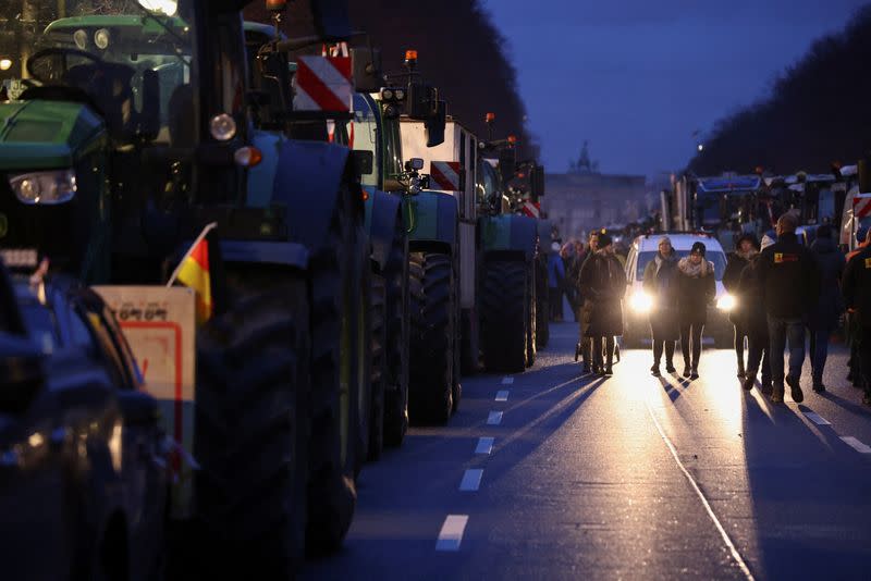 German farmers prepare for a protest against the cut of farm vehicle tax subsidies in Berlin