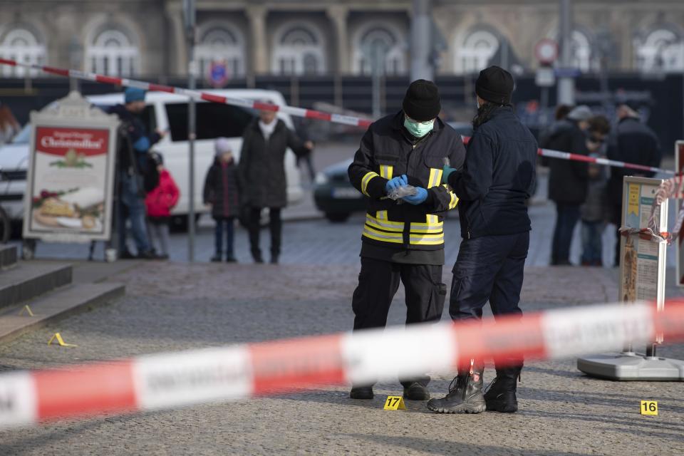 Police officers stand behind a caution tape at the Schinkelwache building in Dresden Monday, Nov. 25, 2019. Authorities in Germany say thieves have carried out a brazen heist at Dresden’s Green Vault, one of the world’s oldest museum containing priceless treasures from around the world. (Sebastian Kahnert/dpa via AP)