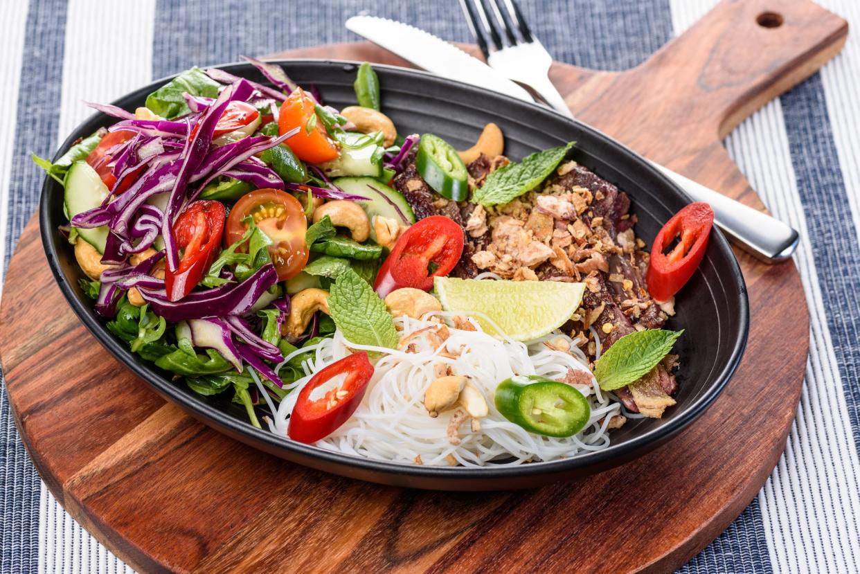 A serving of beef noodle salad, with spicy fresh ingredients for Asian fusion inspired meal