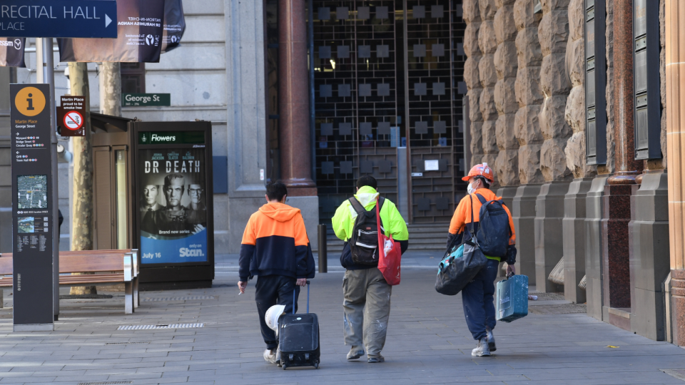 Jobs data: Three construction workers walk through the empty streets of the Sydney CBD.