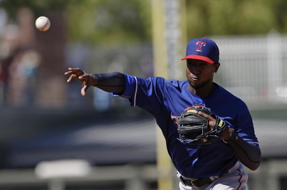 Texas Rangers' Jurickson Profar throws out Kansas City Royals' Jarrod Dyson at first base during the fourth inning of a spring exhibition baseball game, Saturday, March 22, 2014, in Surprise, Ariz. (AP Photo/Darron Cummings)