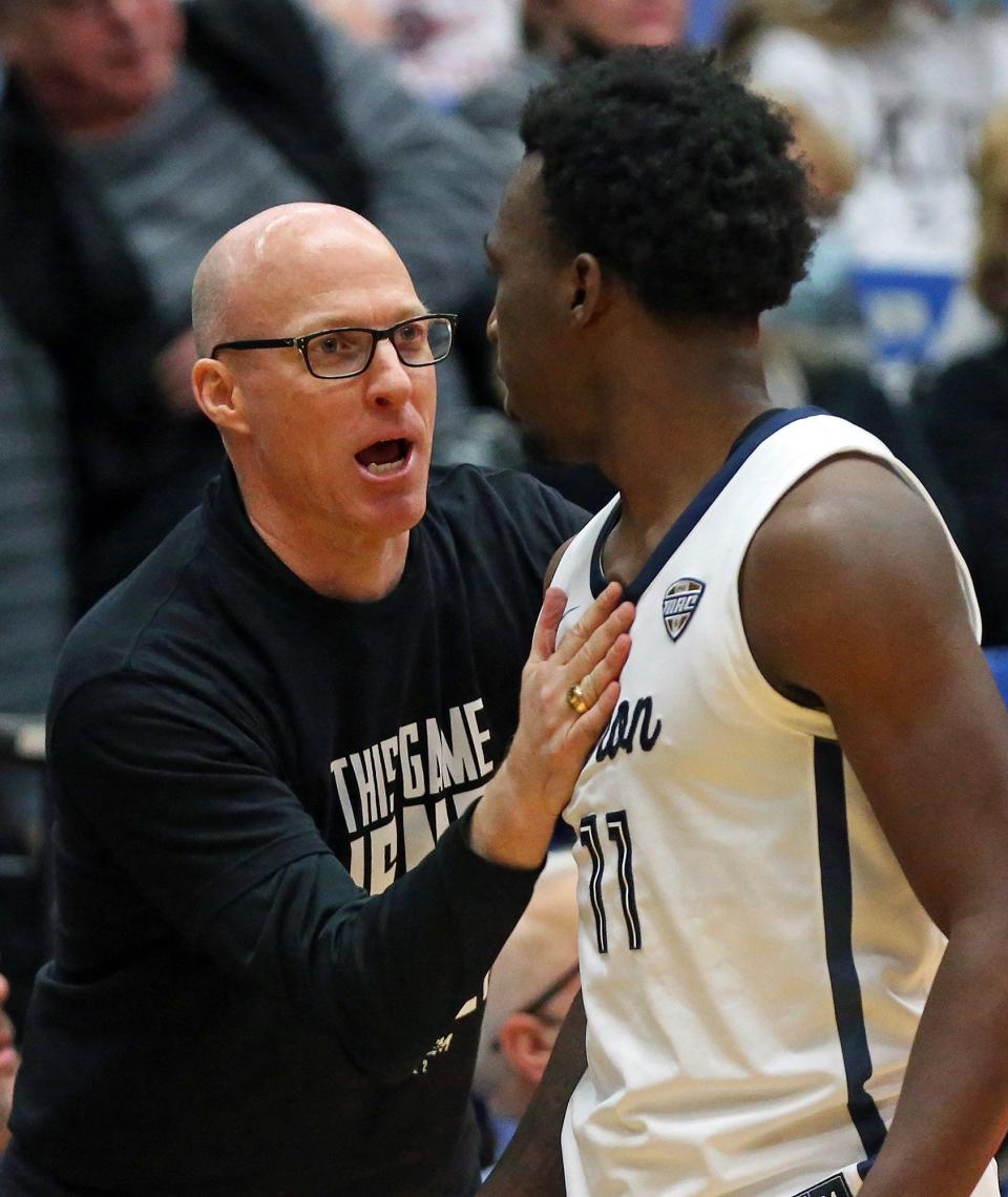 University of Akron coach John Groce  talks with guard Garvin Clarke (11) during the second half of the Zips' 66-55 win over Miami University on Friday night at Rhodes Arena. [Jeff Lange/Beacon Journal]