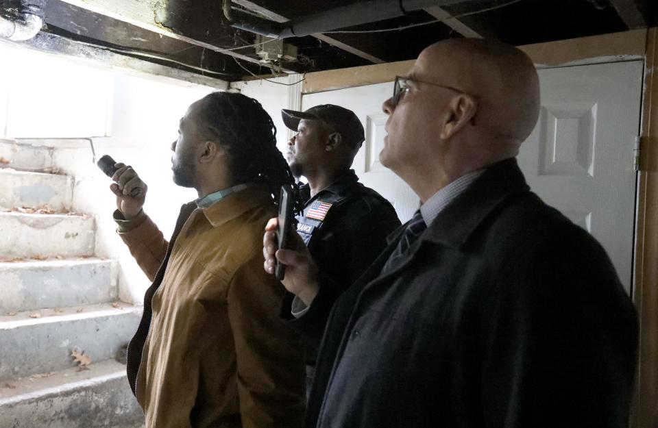 From left, Rockland County Building Inspector, Jack Lavalasse, Fire Inspector, Willer Franck and Director of the Office of Buildings and Codes, Ed Markunas inspect a house next to a two-family house where there was a fatal fire on Lake St. in Spring Valley March 6, 2023.