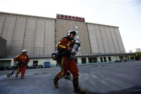 Rescuers walk inside a refrigeration unit of Shanghai Weng's Cold Storage Industrial Co. Ltd., in the Baoshan district of Shanghai August 31, 2013. REUTERS/Aly Song