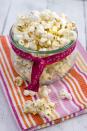 <p>Full of fiber and light on calories, popcorn is a great snack option. If you're feeling a bit wild, you can punch up your health benefits by eating pop <a href="https://www.goodhousekeeping.com/food-recipes/healthy/a37151/cauliflower-popcorn-recipe/" rel="nofollow noopener" target="_blank" data-ylk="slk:caulicorn;elm:context_link;itc:0;sec:content-canvas" class="link ">caulicorn</a>.</p><p>On a cutting board, pile ¼ cup chopped parsley, 1 small clove chopped garlic, ½ teaspoon lemon zest, and 1 tablespoon finely grated Parmigiano Reggiano on top of each other and chop all together until fine. In a large bowl, toss 10 cups air-popped popcorn while spritzing grapeseed oil with a mister. Add the gremolata andand ½ teaspoon salt and toss until coated. Serves 2.</p>