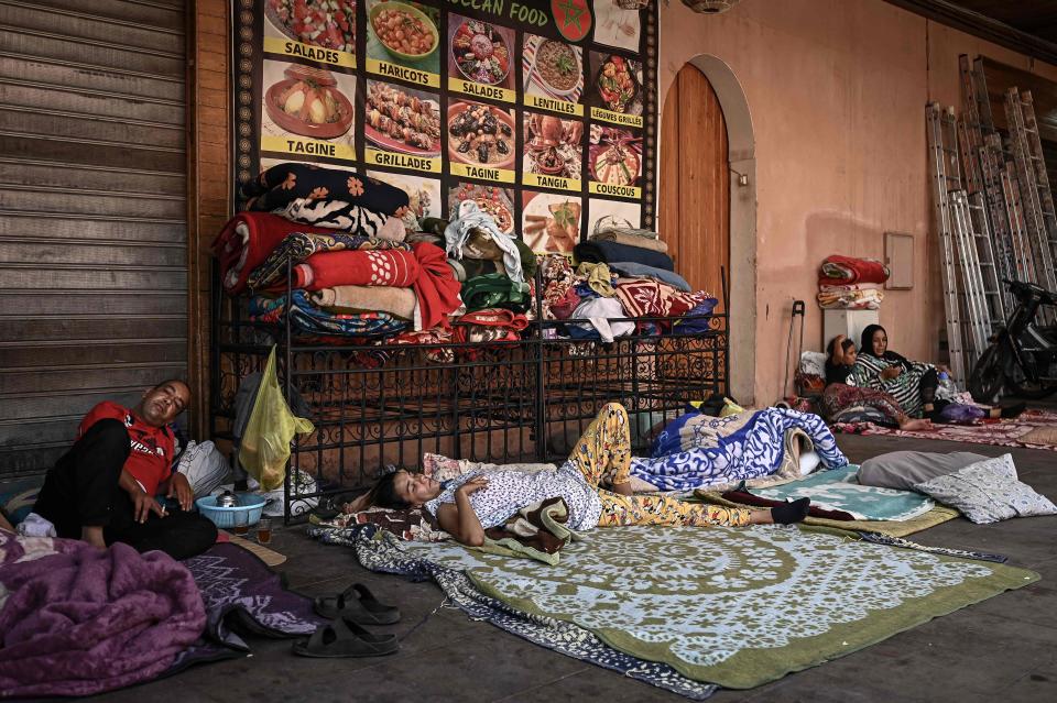 Residents take shelter outside shops in the old quarters of Marrakesh on Sept. 12, 2023, after their houses were deemed unsafe due to the 6.8-magnitude earthquake. Hopes dimmed in Morocco's search for survivors four days after a powerful earthquake killed more than 2,900 people, most of them in remote villages of the High Atlas Mountains.