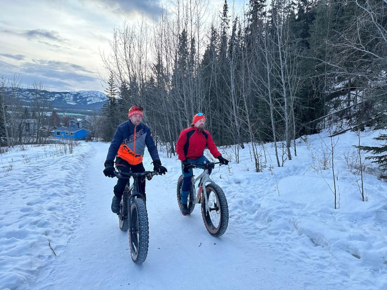 Harri Vaarala, left, and Pekka Tahkola, right, explore Whitehorse's multi-use paths. The two urban planners from Oulu, Finland, were in the Yukon capital this week to offer feedback on the city's active transportation infrastructure.  (Caitrin Pilkington/CBC - image credit)