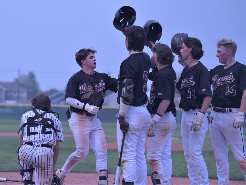 Windsor High School baseball player Chase Thomas is greeted at home plate after hitting a three-run homer during a Class 4A playoff game against Lutheran on Saturday, May 20, 2023, in Windsor, Colo.