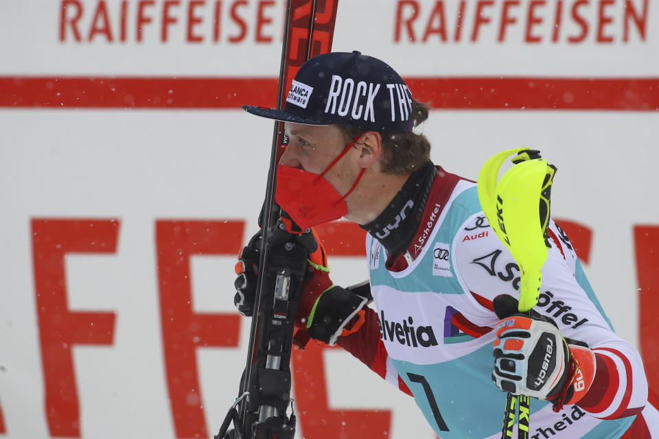 Austria's Manuel Feller celebrates winning an alpine ski, men's World Cup slalom, in Lenzerheide, Switzerland, Sunday, March 21, 2021. (AP Photo/Marco Trovati)