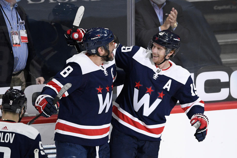 Washington Capitals center Nicklas Backstrom (19), of Sweden, celebrates his goal with left wing Alex Ovechkin (8), of Russia, during the second period of an NHL hockey game against the Philadelphia Flyers, Sunday, Feb. 7, 2021, in Washington. (AP Photo/Nick Wass)