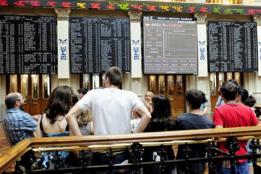 People are seen watching screens at Madrid's Stock Exchange, in 2011. Investors showed deep concern ahead of a Spanish government bond auction due Thursday, fearing Madrid could be thrown back into the centre of the eurozone debt crisis