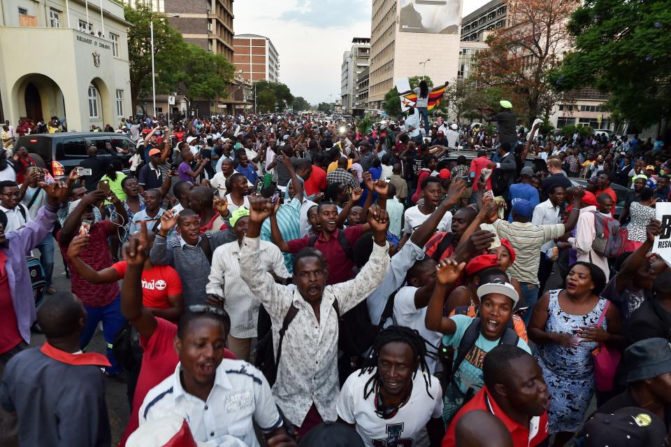 People celebrate in the streets of Harare after the resignation of Zimbabwe's president Robert Mugabe on Nov. 21.