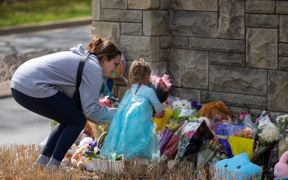Mourners leave flowers outaide the Covenant School on Tuesday - JAMES BREEDEN