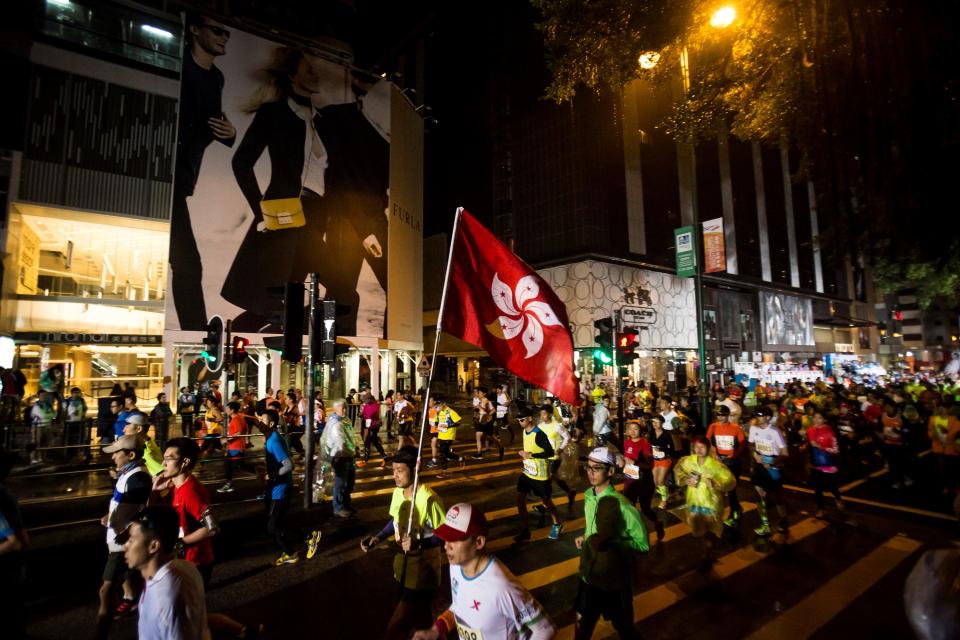 HONG KONG, CHINA - JANUARY 17: Participants take part in the 20th Standard Chartered Hong Kong Marathon on January 17, 2015. The Standard Chartered Hong Kong Marathon is Hong Kong's largest participatory annual sporting event, organized by the Hong Kong Amateur Athletic Association. (Photo by Mike Pickles/Anadolu Agency/Getty Images)