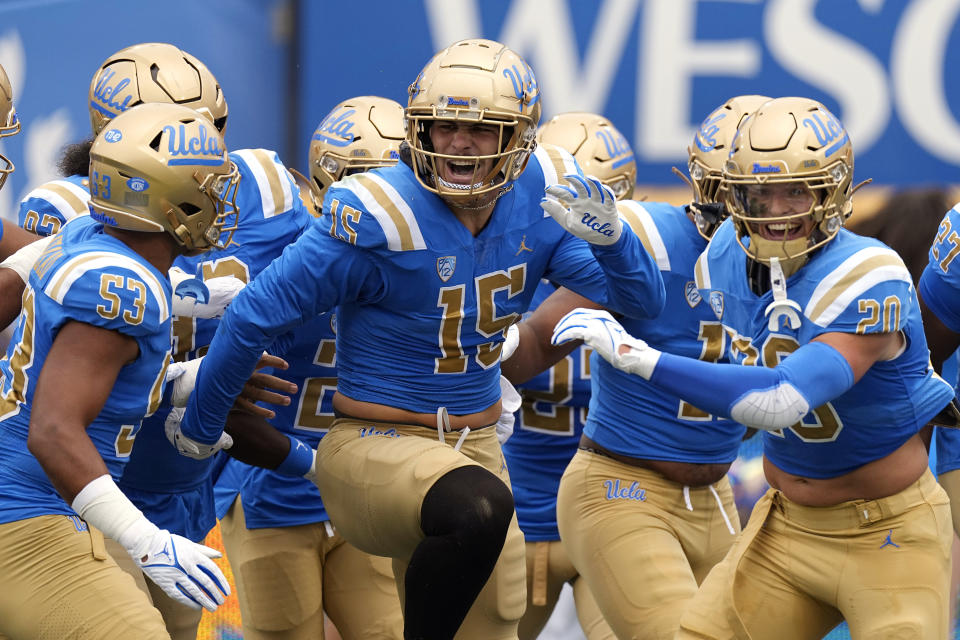 UCLA defensive lineman Laiatu Latu, center, celebrates with teammates after scoring a touchdown on an interception during the first half of an NCAA college football game against North Carolina Central Saturday, Sept. 16, 2023, in Pasadena, Calif. (AP Photo/Mark J. Terrill)