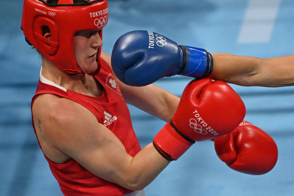 <p>Ireland's Kellie Anne Harrington (red) and Italy's Rebecca Nicoli fight during their women's light (57-60kg) preliminaries round of 16 boxing match at the Tokyo 2020 Olympic Games at the Kokugikan Arena in Tokyo on July 30, 2021. (Photo by Luis ROBAYO / AFP)</p> 