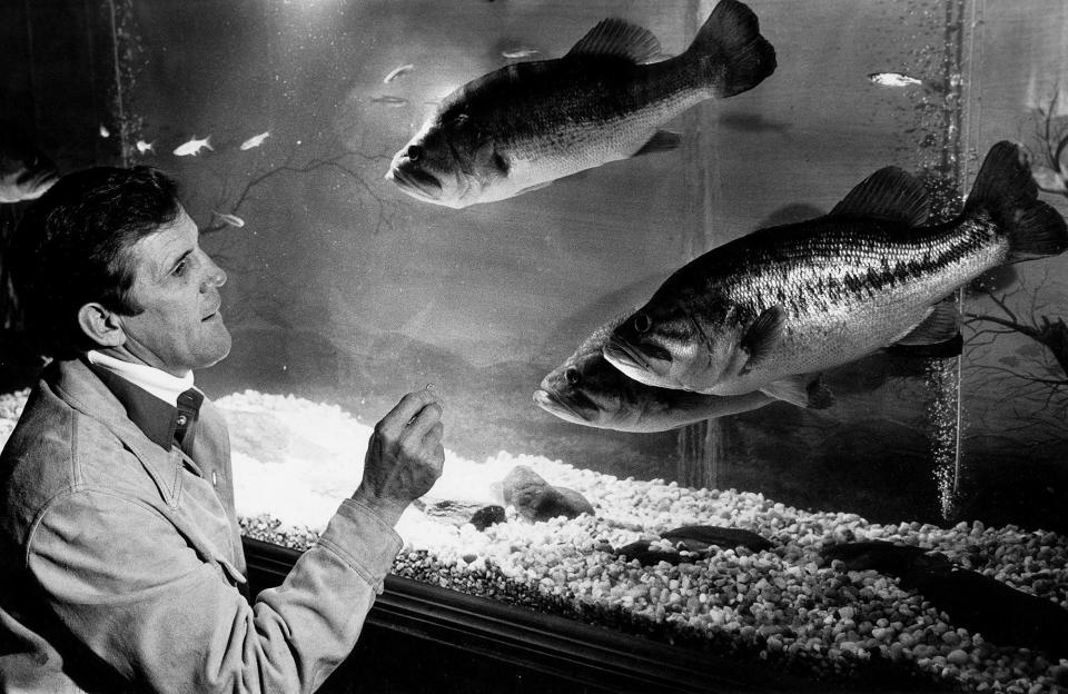 Ray Scott with bass fish in the aquarium at the BASS Headquarters on January 15, 1981.