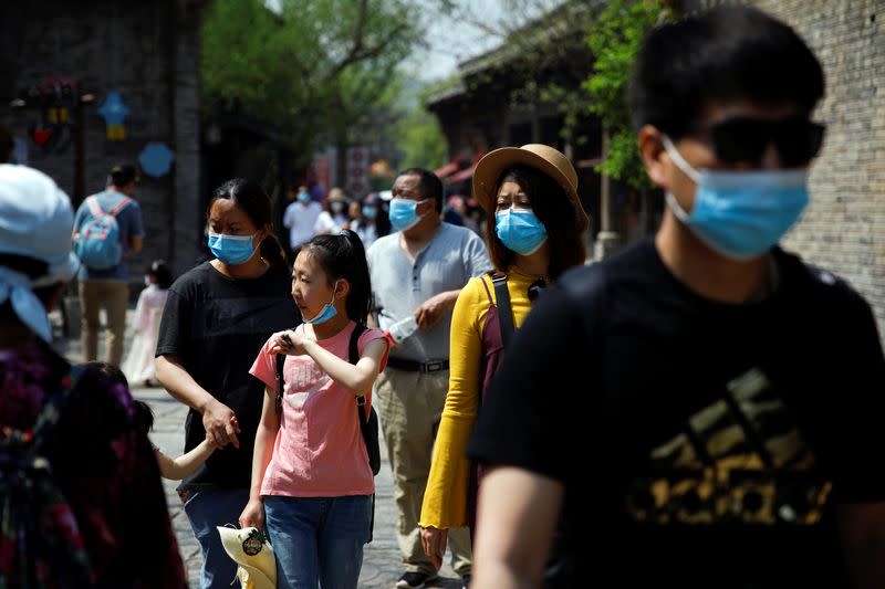 People wearing face masks visit Gubei Water Town on the first day of the five-day Labour Day holiday, following the coronavirus disease (COVID-19) outbreak, on the outskirts of Beijing