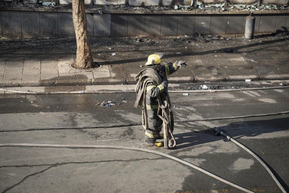 A fireman works at the scene of a deadly blaze in downtown Johannesburg, Thursday, Aug. 31, 2023. Dozens died when a fire ripped through a multi-story building in Johannesburg, South Africa's biggest city, emergency services said Thursday. (AP Photo)