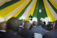 Kenya's President-elect William Ruto, stands under a photograph of current president Uhuru Kenyatta as he addresses the media at his official residence of the deputy president in the Karen area of Nairobi, Kenya Wednesday, Aug. 17, 2022. (AP Photo/Mosa'ab Elshamy)