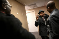 Erik Anderson, left, of Trenton, N.J., is greeted by Brooklyn Center Mayor-elect Mike Elliott, center, before Elliot's inauguration ceremony, Wednesday, Jan. 2, 2019, at the Brooklyn Center Community Center, in Brooklyn Center, Minn. Elliott is the city's first Black and first Liberian American mayor. Elliott, who emigrated from Liberia as a child, is finding just how difficult it is to turn the page on the nation’s racial history as he handles the fallout from a police shooting. (Aaron Lavinsky/Star Tribune via AP)