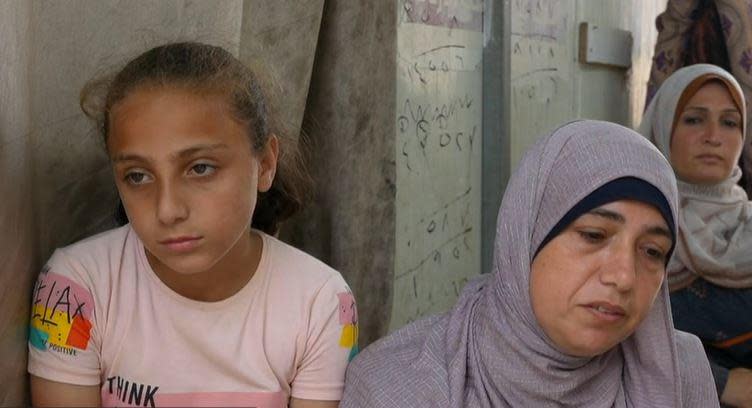 Dema Abu Jebara, 10, sits next to her mother Jamila (center) as they speak with CBS News in a makeshift camp for displaced Palestinians in Deir al Balah, in the central Gaza Strip, May 12, 2024.  / Credit: CBS News