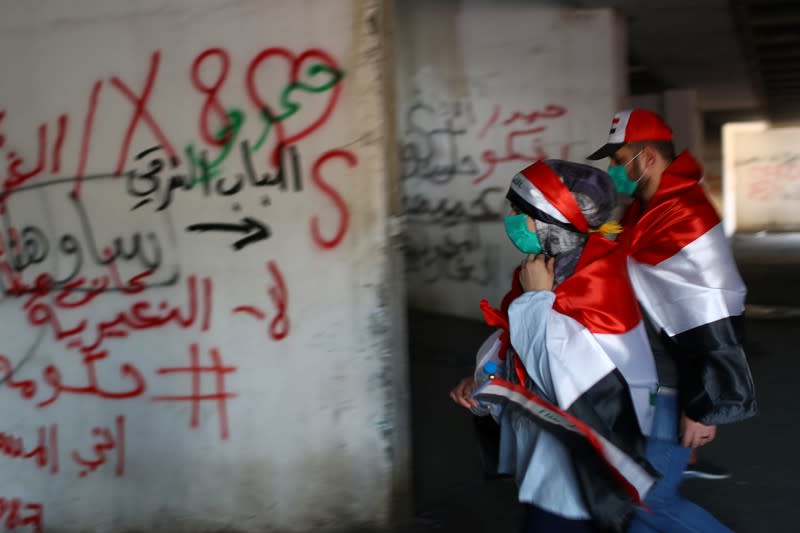 Iraqi demonstrators are seen inside the high-rise building, called by Iraqi the Turkish Restaurant Building, during anti-government protests in Baghdad