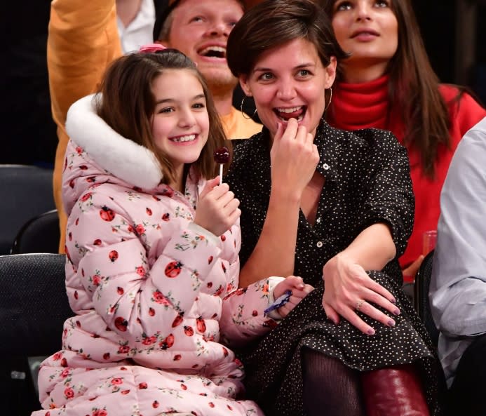 Suri Cruise and Katie Holmes attend the Oklahoma City Thunder Vs New York Knicks game at Madison Square Garden on December 16, 2017 in New York City. [Photo by James Devaney/Getty Images]