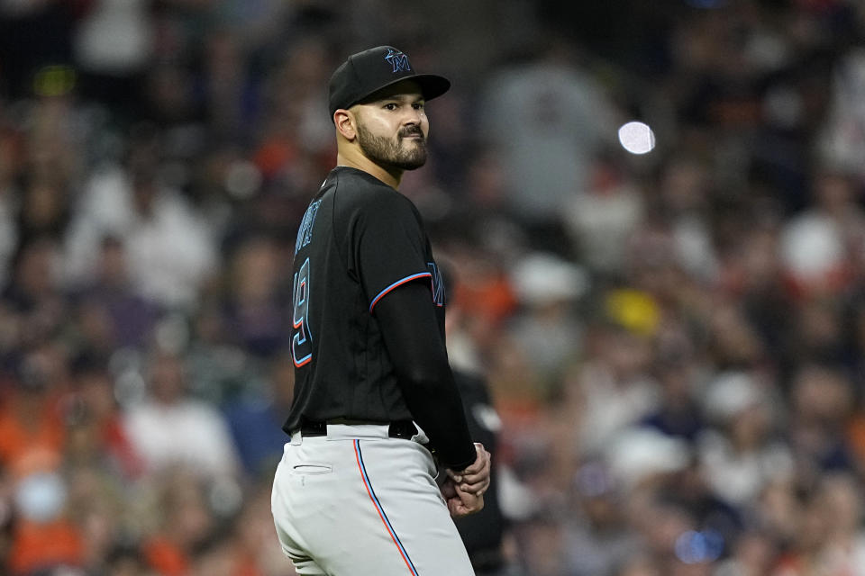 Miami Marlins starting pitcher Pablo Lopez holds his wrist after being hit by a ball off the bat of Houston Astros' Michael Brantley during the fifth inning of a baseball game Friday, June 10, 2022, in Houston. (AP Photo/David J. Phillip)