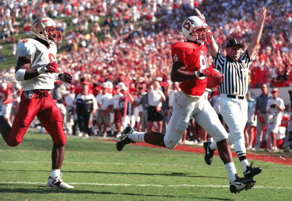 N.C. State wide receiver Torry Holt scores for the Wolfpack during an upset win over Florida State in 1998.