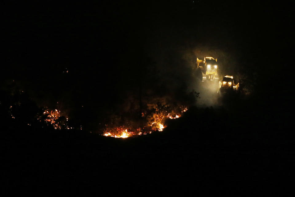 Two firefighting bulldozers construct a containment line while battling the Jerusalem Fire near Morgan Valley Road on August 11, 2015 in Lower Lake, California. (Photo by Stephen Lam/Getty Images)