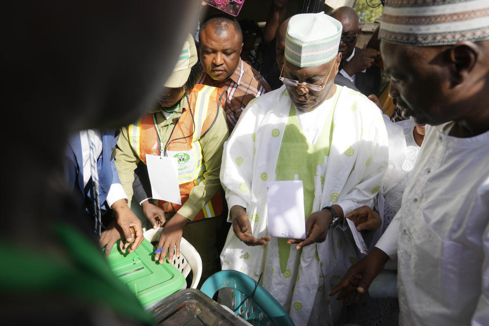 Atiku Abubakar, presidential candidate of the Peoples Democratic party, centre, Nigeria's opposition party, is seen during the presidential and parliamentary elections in Yola, Nigeria, Saturday, Feb. 25, 2023. Voters in Africa's most populous nation are heading to the polls Saturday to choose a new president, following the second and final term of incumbent Muhammadu Buhari. (AP Photo/Sunday Alamba)