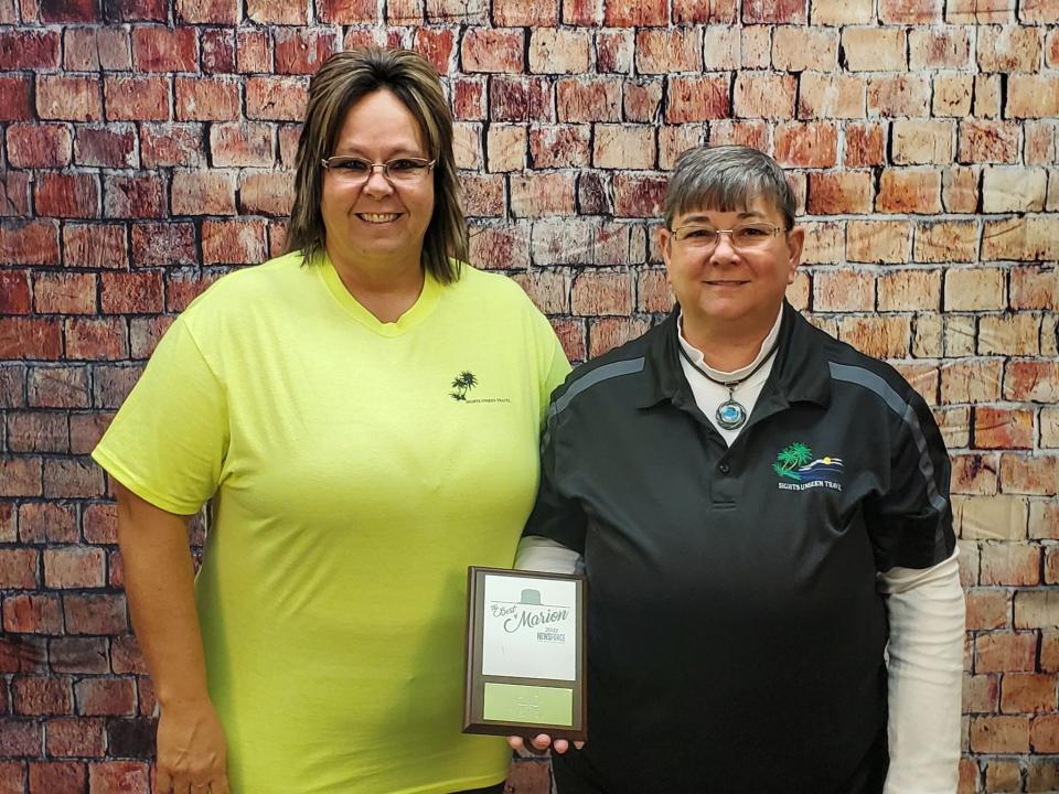 Sherry Nelson (left) and Jill Chitwood display their award for Best in Marion for Travel Agency in 2022 from NewsForce24/7. They pride themselves on providing superb customer service.