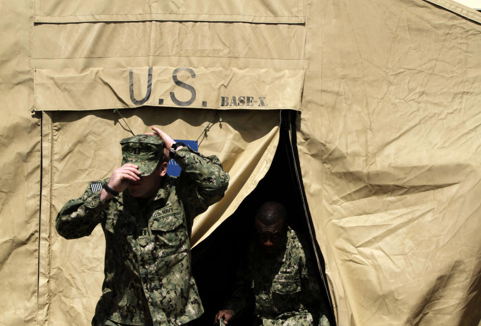 U.S. Navy personnel leave a military tent set up at the U.S. Navy base in Manama, Bahrain, on Thursday, Sept. 20, 2012, where a major exercise is under way involving air, sea and undersea forces from more than 20 nations to respond to simulated sea-mine attacks in international waters. The sea maneuvers, a demonstration of international resolve to ensure maritime security, are being held in the Persian Gulf, the Gulf of Oman and the Gulf of Aden. (AP Photo/Hasan Jamali)