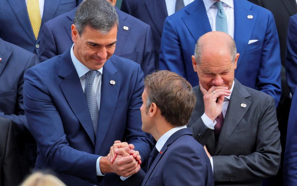 Spanish prime minister Pedro Sanchez and French president Emmanuel Macron talk at the opening ceremony of the Summit on Peace in Ukraine at the Buergenstock Resort in Stansstad near Lucerne, Switzerland, June 15, 2024.