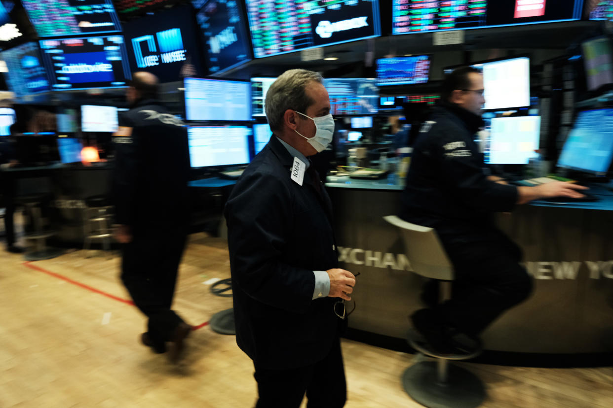 NEW YORK, NEW YORK - MARCH 20: Traders, some in medical masks, work on the floor of the New York Stock Exchange (NYSE) on March 20, 2020 in New York City. Trading on the floor will temporarily become fully electronic starting on Monday to protect employees from spreading the coronavirus. The Dow fell over 500 points on Friday as investors continue to show concerns over COVID-19.  (Photo by Spencer Platt/Getty Images)