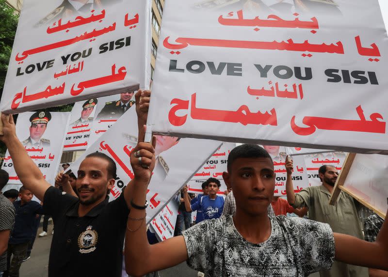 Supports of al-Sisi attend a rally to back his candidacy in the presidential elections, in Giza