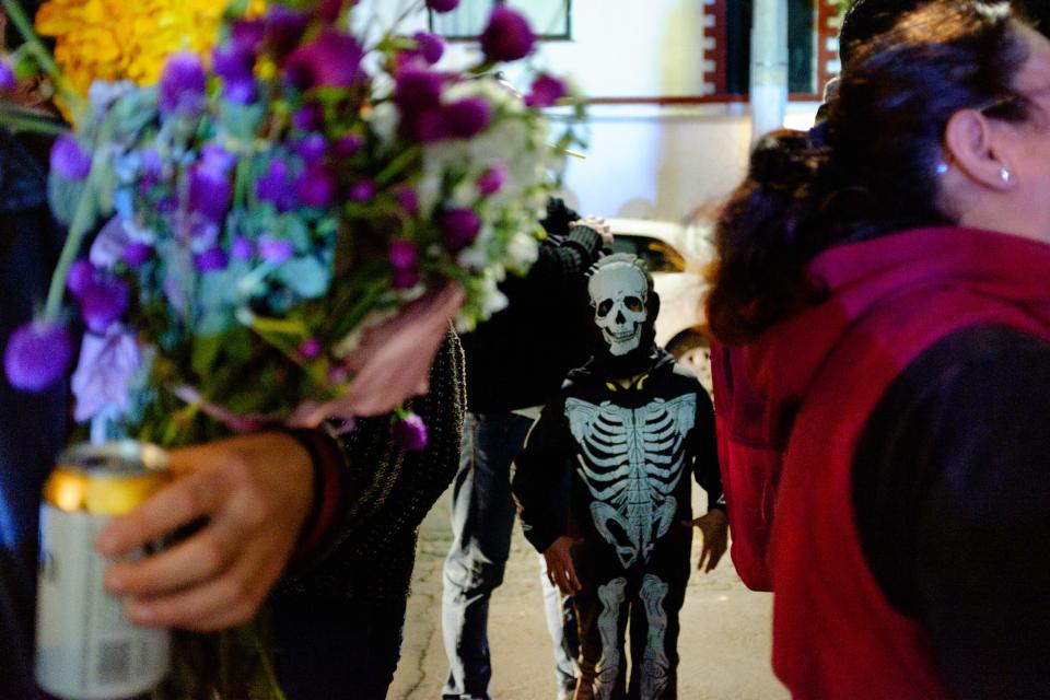 A young reveler in a skeleton costume.