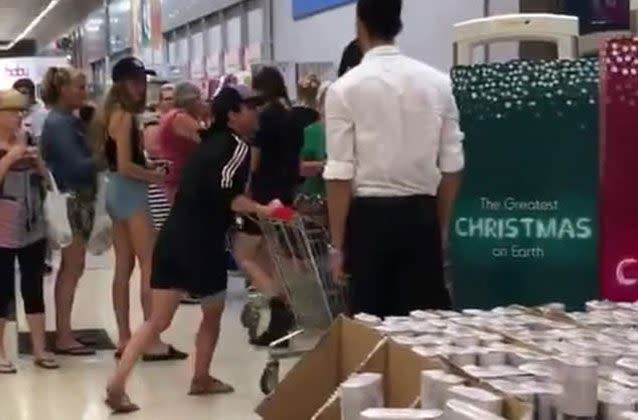 The woman rams her trolley into him at the security gates, as shocked Christmas shoppers watched. Source: Facebook