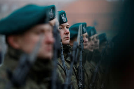 Recruit Damian Krasnodebski, 27, an architect, looks on during a swearing-in ceremony after his 16-day basic training for Poland's Territorial Defence Forces, in Bialystok, Poland, December 16, 2017. REUTERS/Kacper Pempel/Files