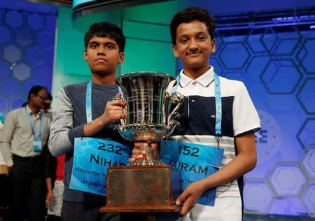 Co-champions Nihar Saireddy Janga (L) and Jairam Jagadeesh Hathwar hold their trophy upon completion of the final round of Scripps National Spelling Bee at National Harbor in Maryland, U.S. May 26, 2016. REUTERS/Kevin Lamarque