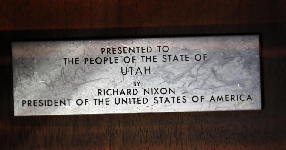 This Wednesday, Aug. 22, 2018, photo shows a plate mounted on a wooden plaque that holds moon rocks encased in acrylic at the Clark Planetarium, in Salt Lake City. A former NASA investigator who has spent more than a decade tracking missing moon rocks is closing in on his goal of finding all 50 lunar samples gifted to U.S. states after Neil Armstrong's first steps on the moon. In recent weeks, two more of the moon rocks that dropped off the radar after the 1969 Apollo 11 mission have been located in Louisiana and Utah. (AP Photo/Rick Bowmer)