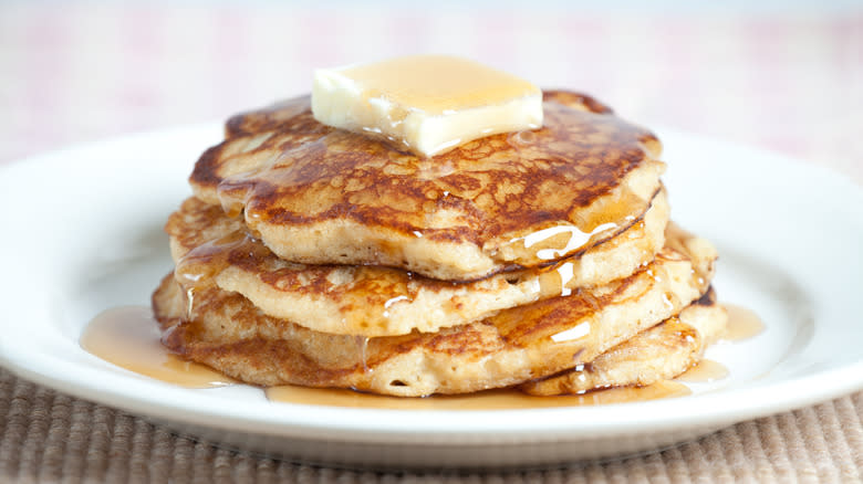 fluffy pancakes drizzled with syrup