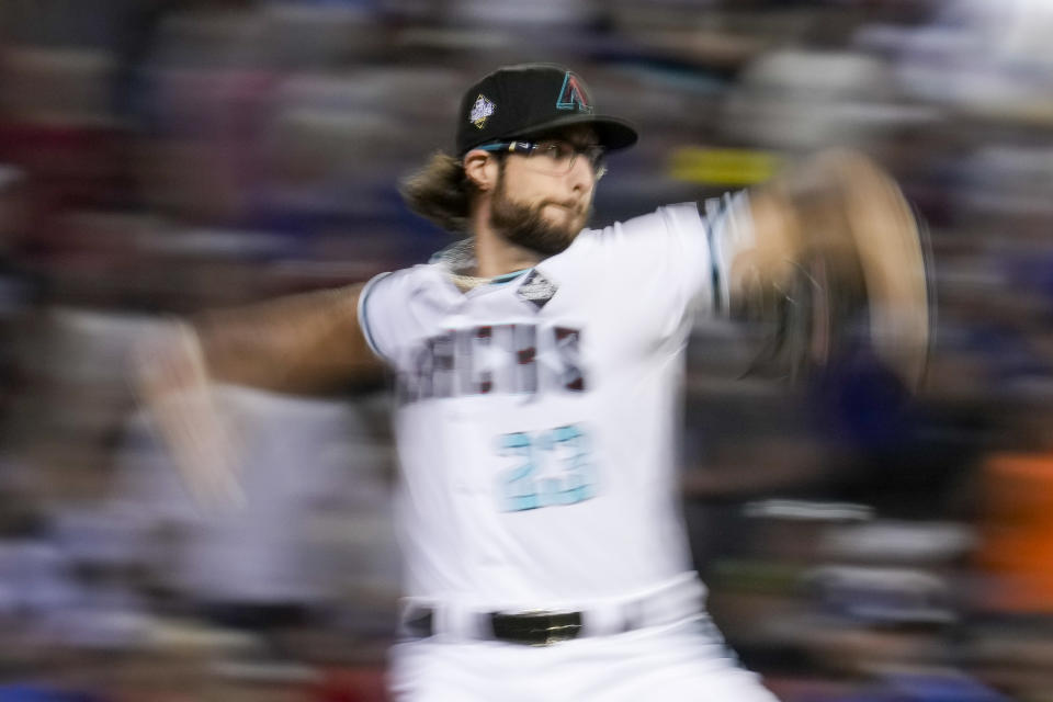 Arizona Diamondbacks starting pitcher Zac Gallen throws against the Texas Rangers during the fourth inning in Game 5 of the baseball World Series Wednesday, Nov. 1, 2023, in Phoenix. (AP Photo/Godofredo A. Vásquez)