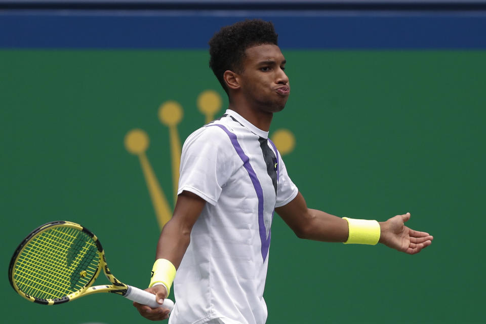 Felix Auger-Aliassime of Canada reacts as he plays against Stefanos Tsitsipas of Greece in the men's singles match at the Shanghai Masters tennis tournament at Qizhong Forest Sports City Tennis Center in Shanghai, China, Wednesday, Oct. 9, 2019. (AP Photo/Andy Wong)