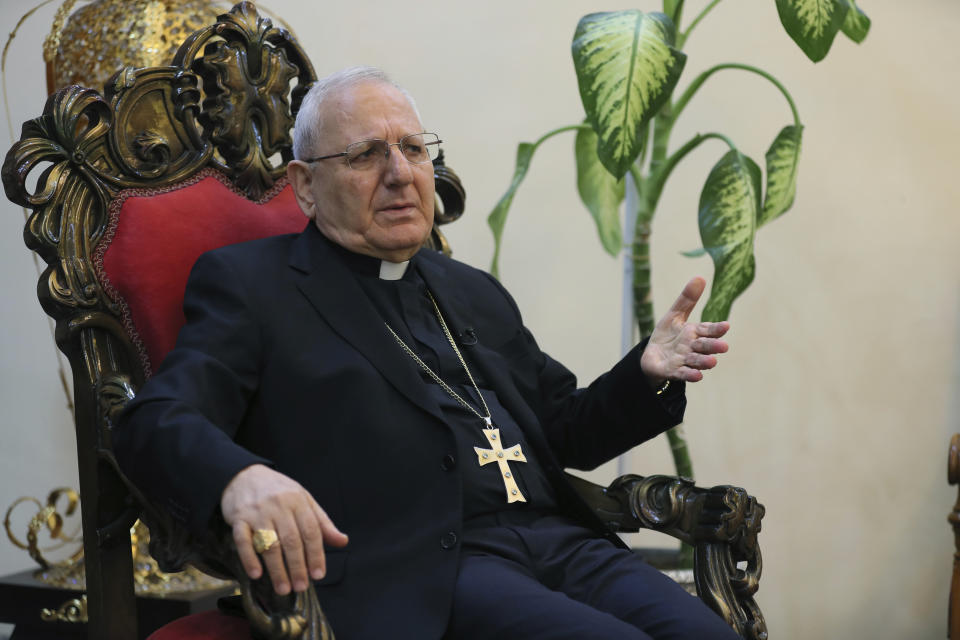 In this Thursday, Dec. 5, 2019 photo, Cardinal Louis Raphael Sako, patriarch of the Chaldean Church, speaks during an interview with The Associated Press in Baghdad, Iraq. Leaders of Iraq's Christians unanimously cancelled Christmas-related celebrations in solidarity with the protest movement - but the aims of their stance go deeper than tinsel and fairy lights. In the slogans calling for a united Iraq, Christians see hope for much needed change from a sectarian system that has long marginalized them. (AP Photo/Khalid Mohammed)