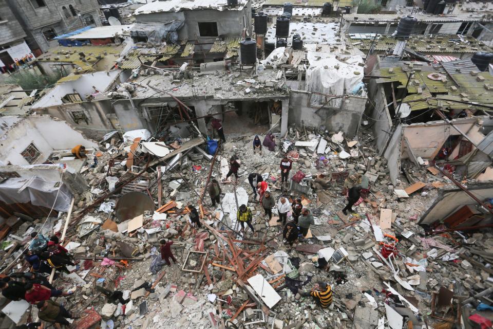 Palestinians look at destruction after Israeli strikes on Rafah in Gaza on Wednesday, the same day Sir Keir Starmer lost 10 shadow ministers and parliamentary aides in a major rebellion over his stance on the war in the Strip (Copyright 2023 The Associated Press. All rights reserved.)